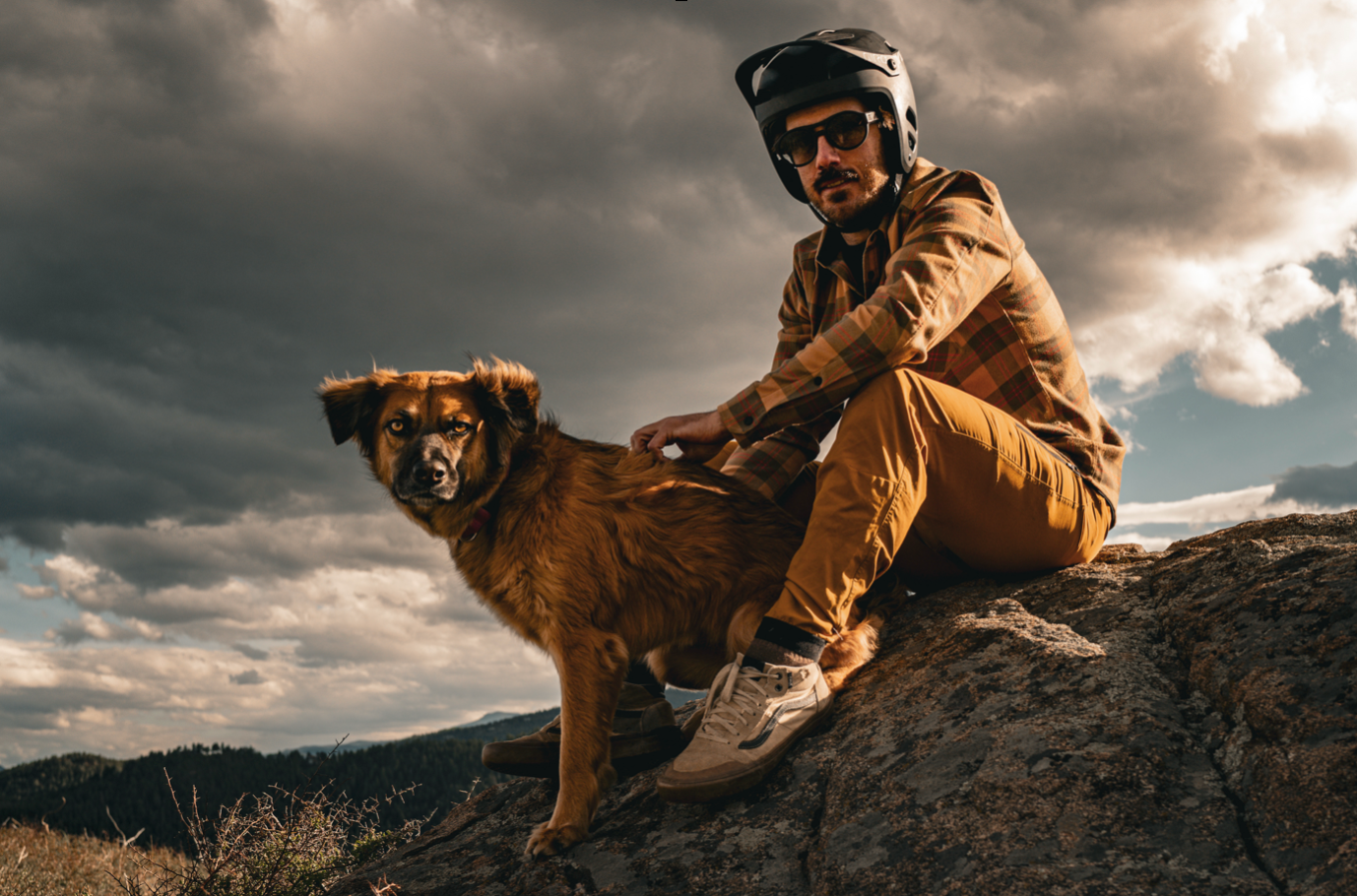 Shawn Neer and his dog sitting on a rock
