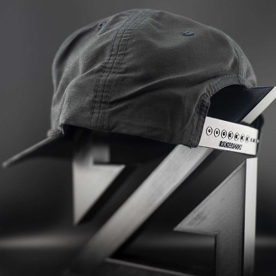 Black Zirkel Ridge Cap with a Richardson brand label on a metallic surface against a dark background