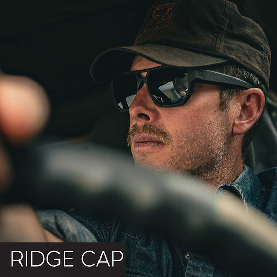 Man wearing sunglasses and a cap with 'Ridge Cap' text