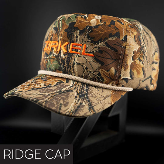 Camouflage cap with 'Zerkel' branding on a black background
