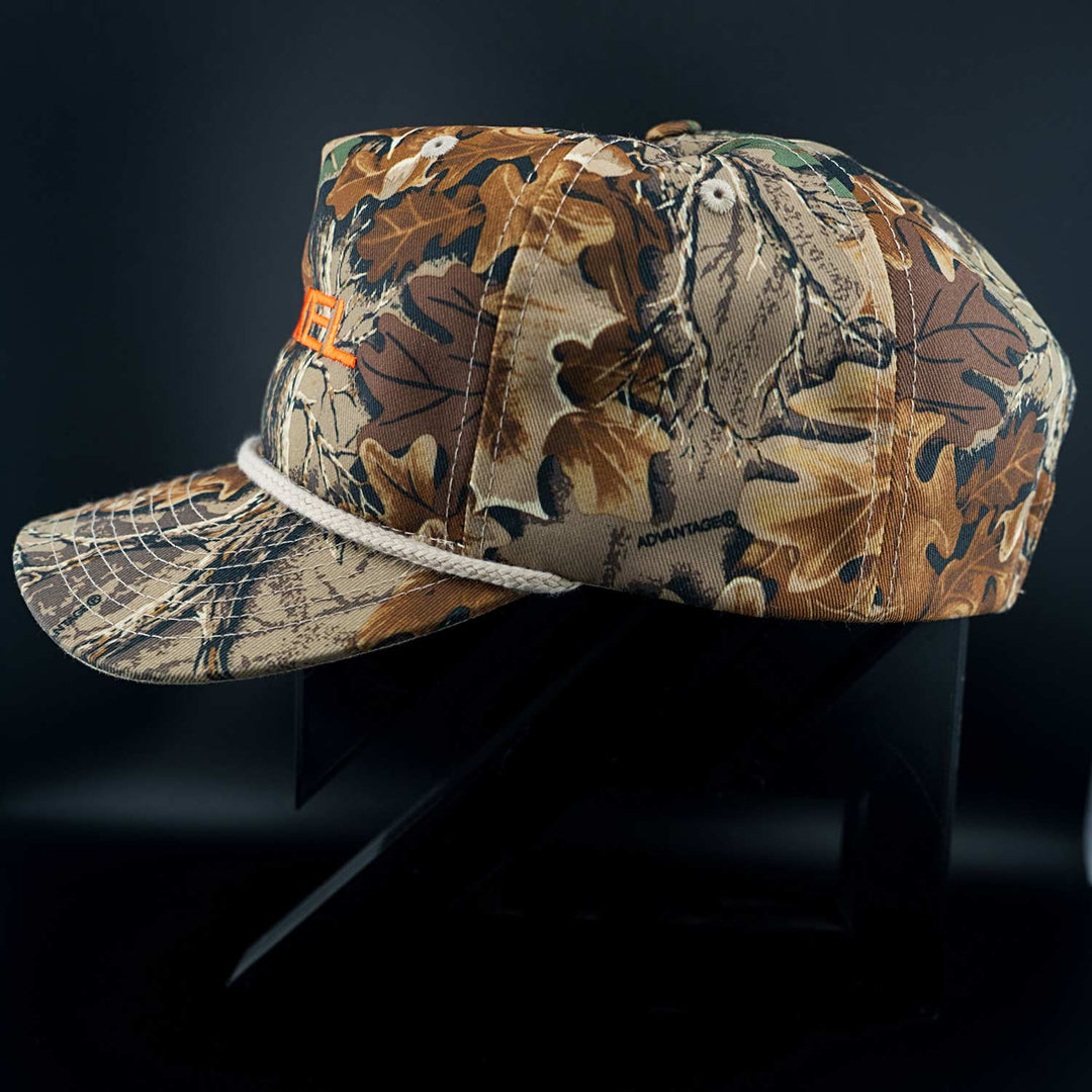 Camouflage-patterned Zirkel Ridge Cap with a brand logo on a dark background